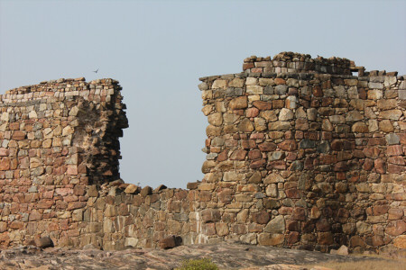 a stone wall with a large collapsed hole in the center