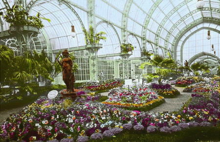 a decorated garden pathway through a large greenhouse