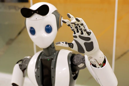 waist-up picture of a humanoid robot waving